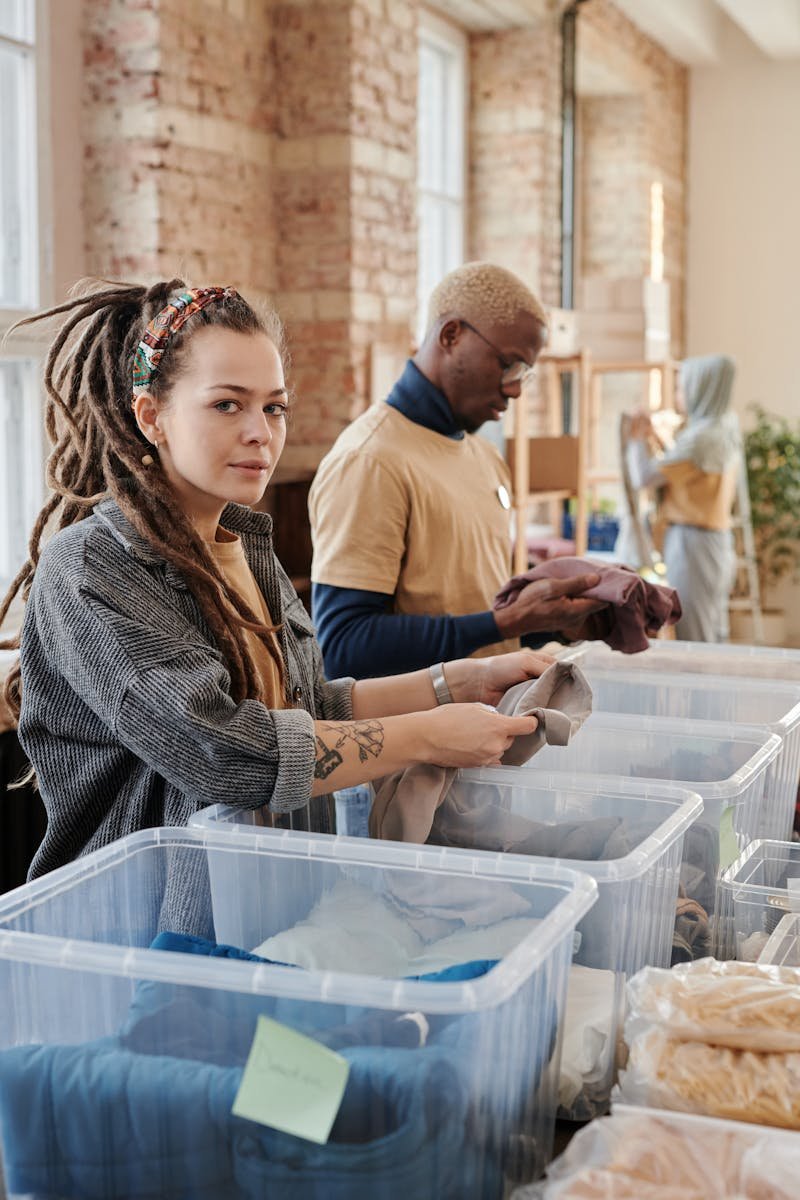 Woman with Dreadlocks Holding a Gray Shirt