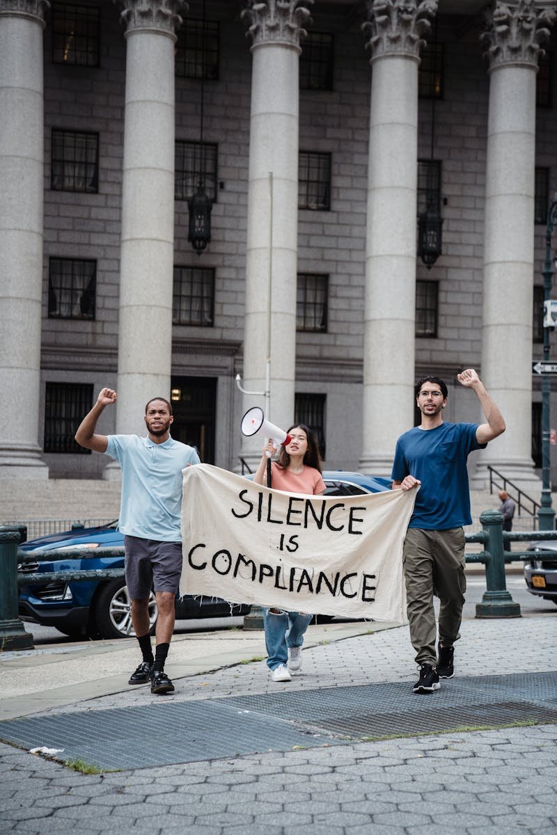 Protesters Holding a Banner with a Slogan